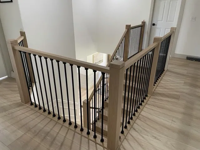 Oak staircase railing matched to hardwood floors in a Seattle home