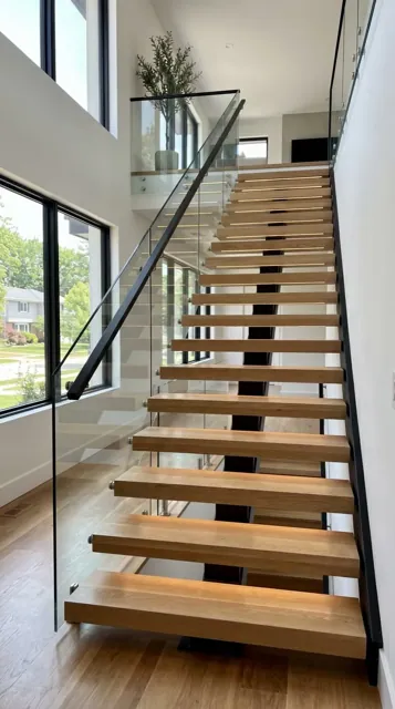 Open-riser floating staircase with glass railing in a Seattle home