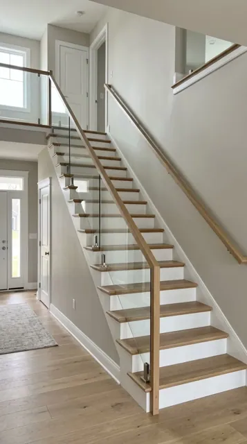 Glass railing with oak treads on a staircase in a Seattle home