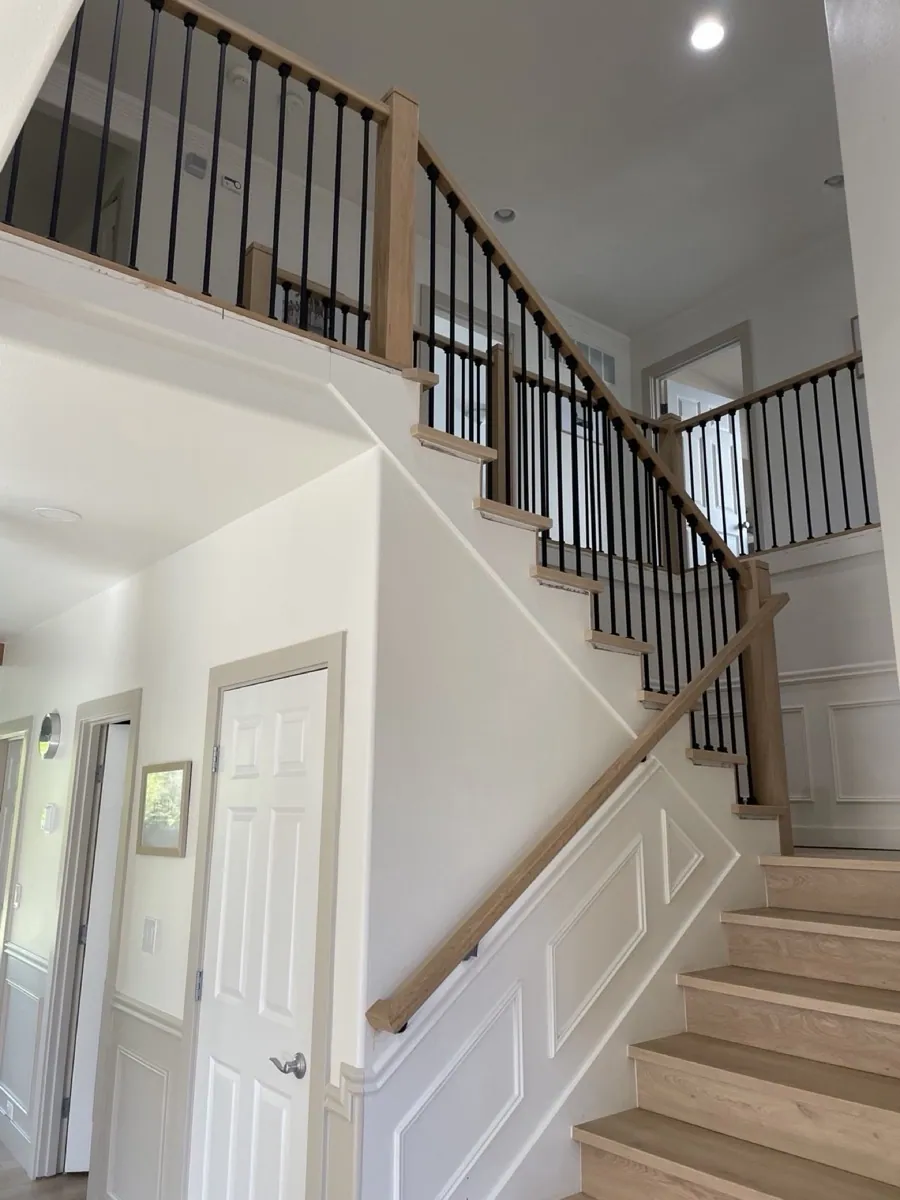 Two-story oak staircase with iron balusters in Bellevue